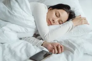 Photo by Ketut Subiyanto: https://www.pexels.com/photo/woman-sleeping-in-bed-near-smartphone-4473864/ Alt: Woman sleeping peacefully
