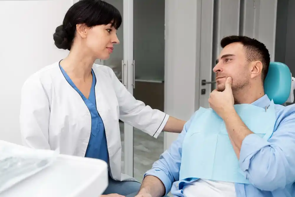 man holding jaw and in dental chair